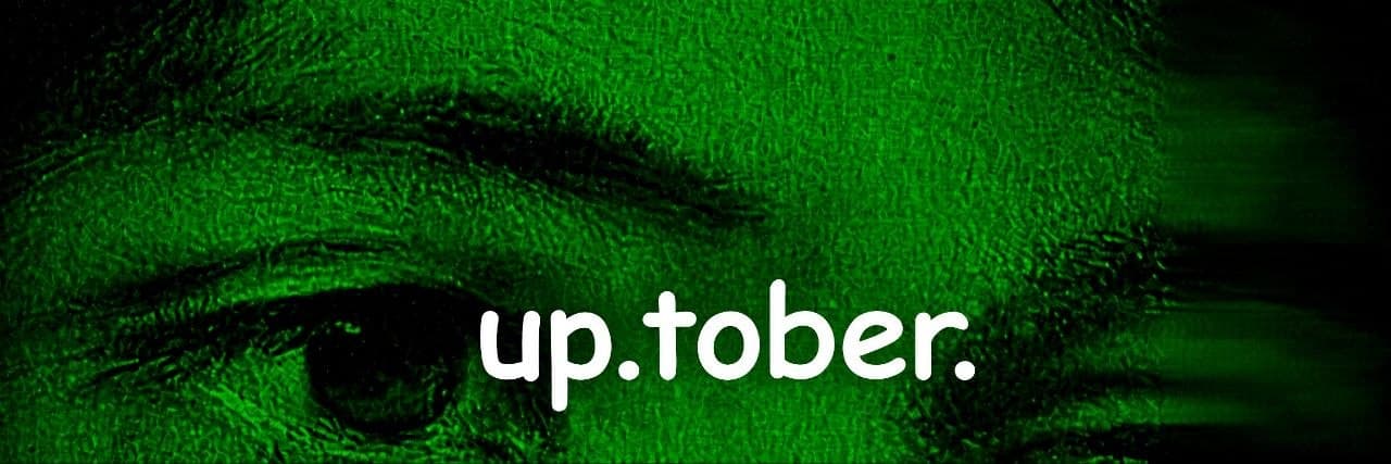 Close-up of an eye in green tones with the words "up.tober."
